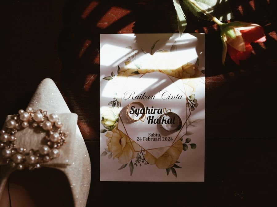 Wedding invitation decorated with flowers and rings